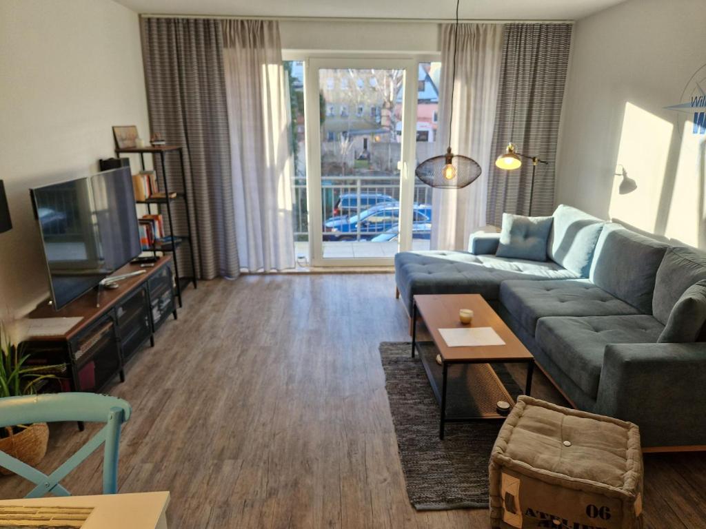 a living room with a couch and a tv at Walfisch im Zentrum - ABC350 in Wismar
