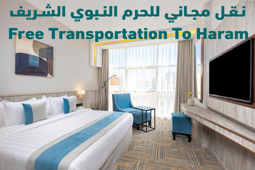 a hotel room with a bed and a flat screen tv at The Seasons Hotel in Al Madinah
