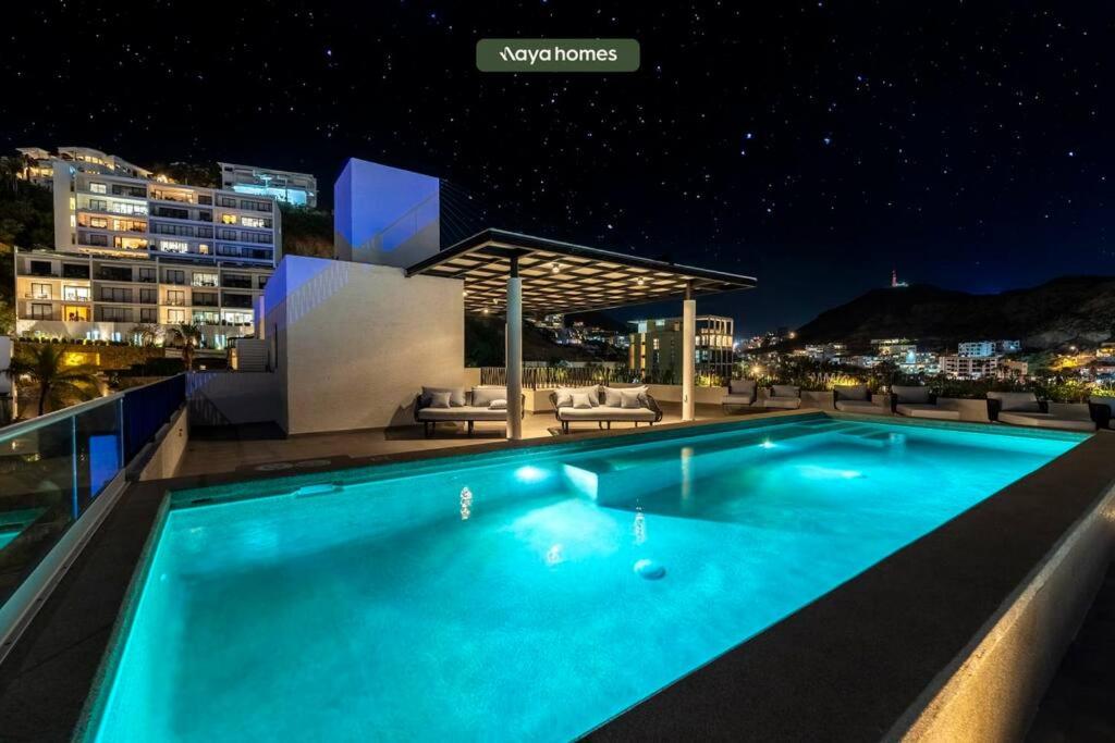a swimming pool at night with a view of the city at Condo near Marina - Downtown - Pool - King in Cabo San Lucas