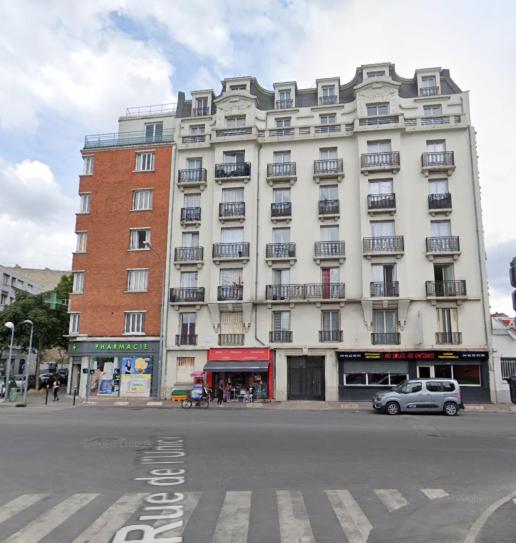 a large white building with a car parked in front of it at Parisian Skyline Oasis: Panoramic Elegance, Luxury at Your Doorstep in Saint-Ouen