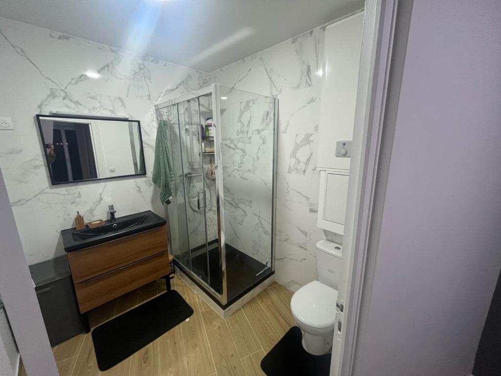 a bathroom with a shower and a sink and a toilet at Parisian Skyline Oasis: Panoramic Elegance, Luxury at Your Doorstep in Saint-Ouen