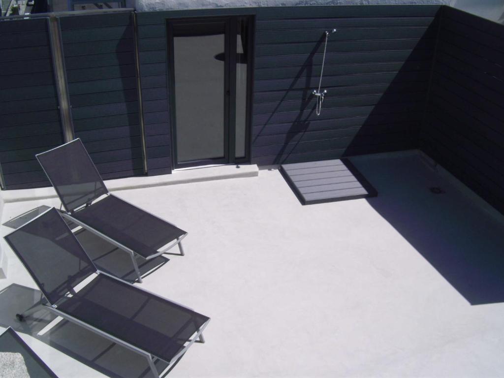 two chairs and a pool on a patio at Zenit Vigo in Vigo
