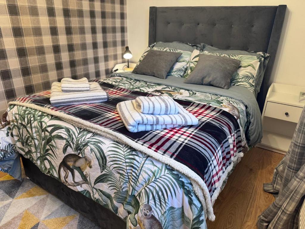 a bed with towels on it in a bedroom at Brick lodge house in Castle Donington