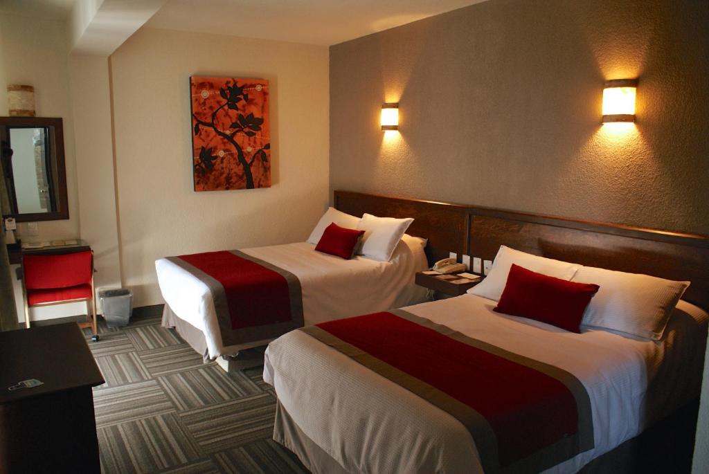 Postel nebo postele na pokoji v ubytování Ramada Plaza by Wyndham Leon