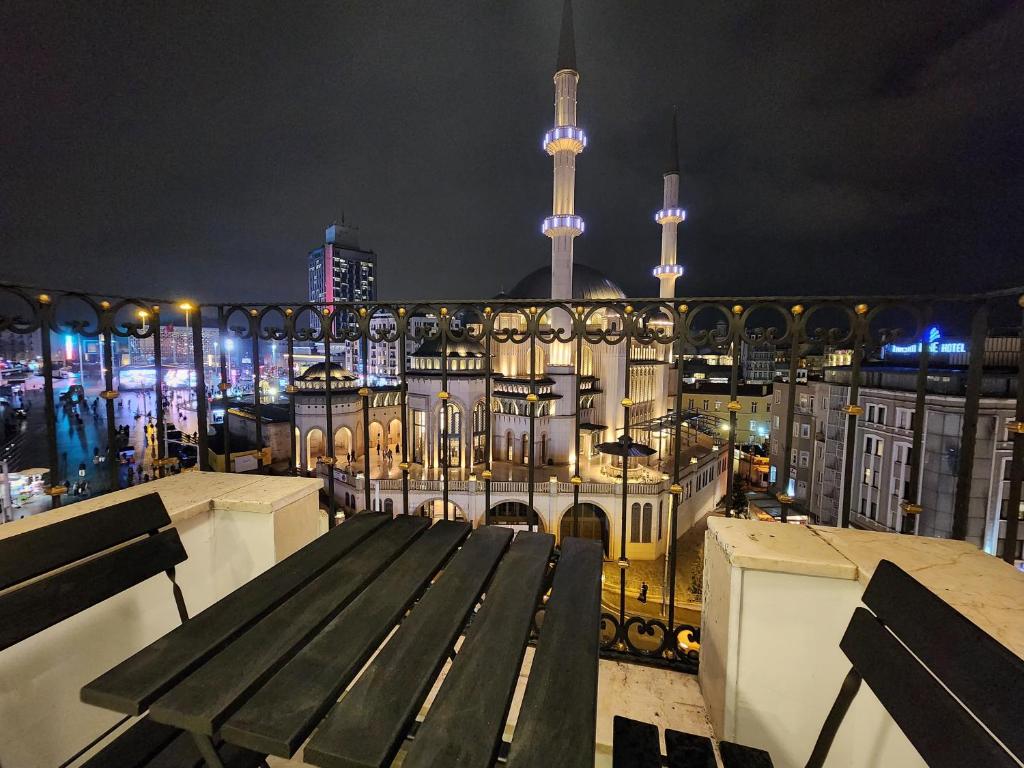 a view of a city at night with a bench at Taksim Landhouse Hotel 1 Min to Taksim Square in Istanbul