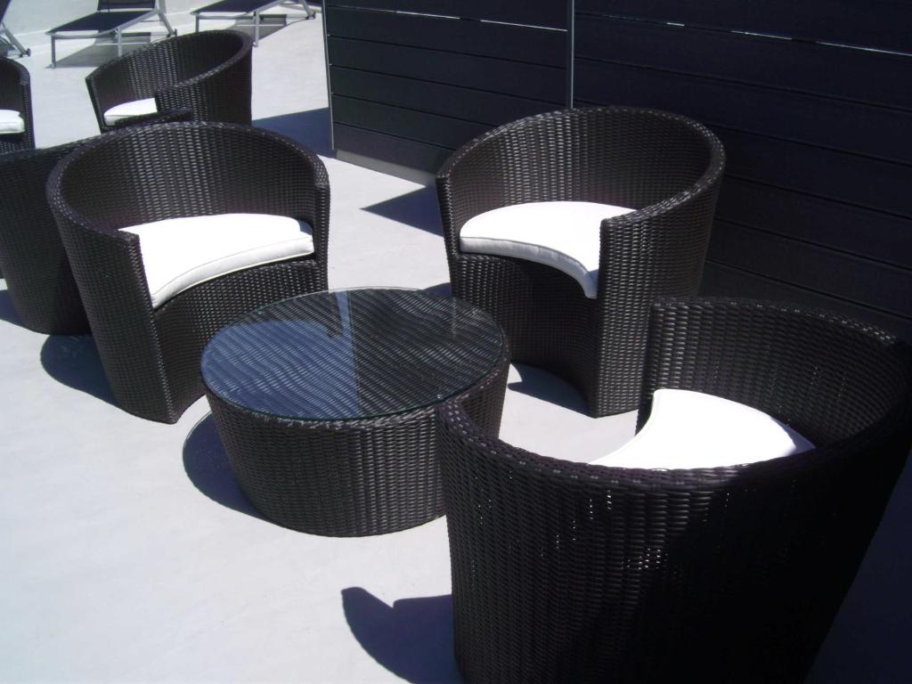 a group of wicker chairs and a table at Zenit Vigo in Vigo