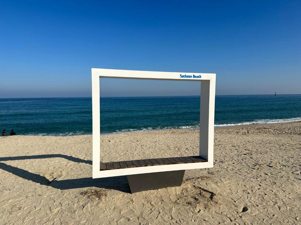 a mirror on the beach with the ocean in the background at Sacheon Songlim in Gangneung