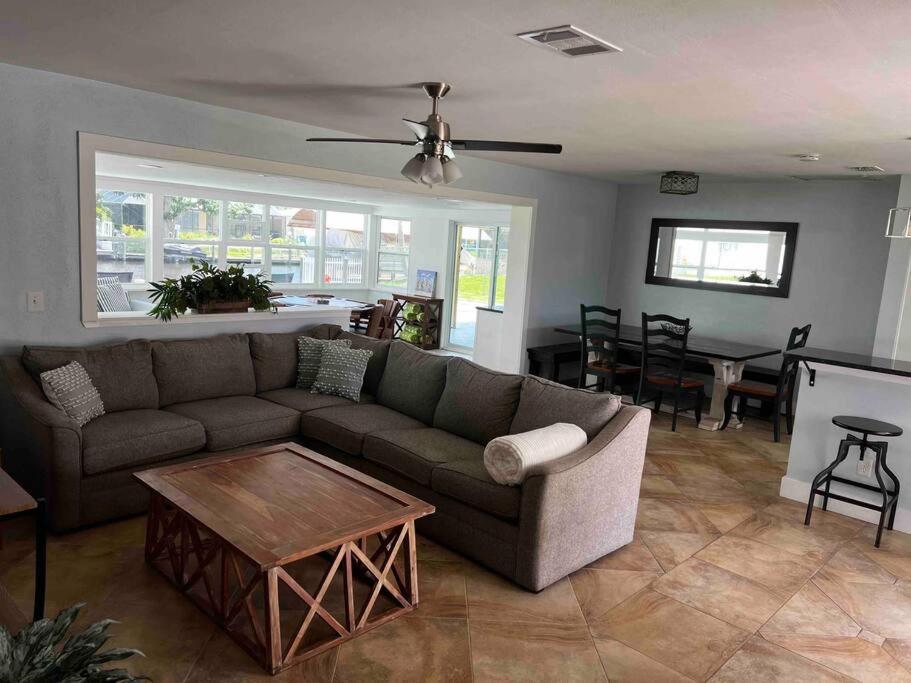 a living room with a couch and a table at Gulf Access Canal Home! in Cape Coral