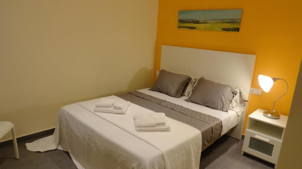 a bedroom with a bed with two towels on it at Apartamento zona playa de San Sebastian in Sitges