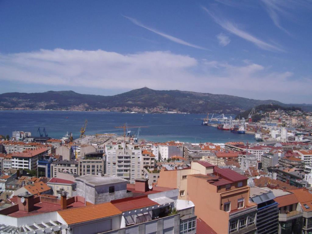 a city with a view of the water and buildings at Zenit Vigo in Vigo