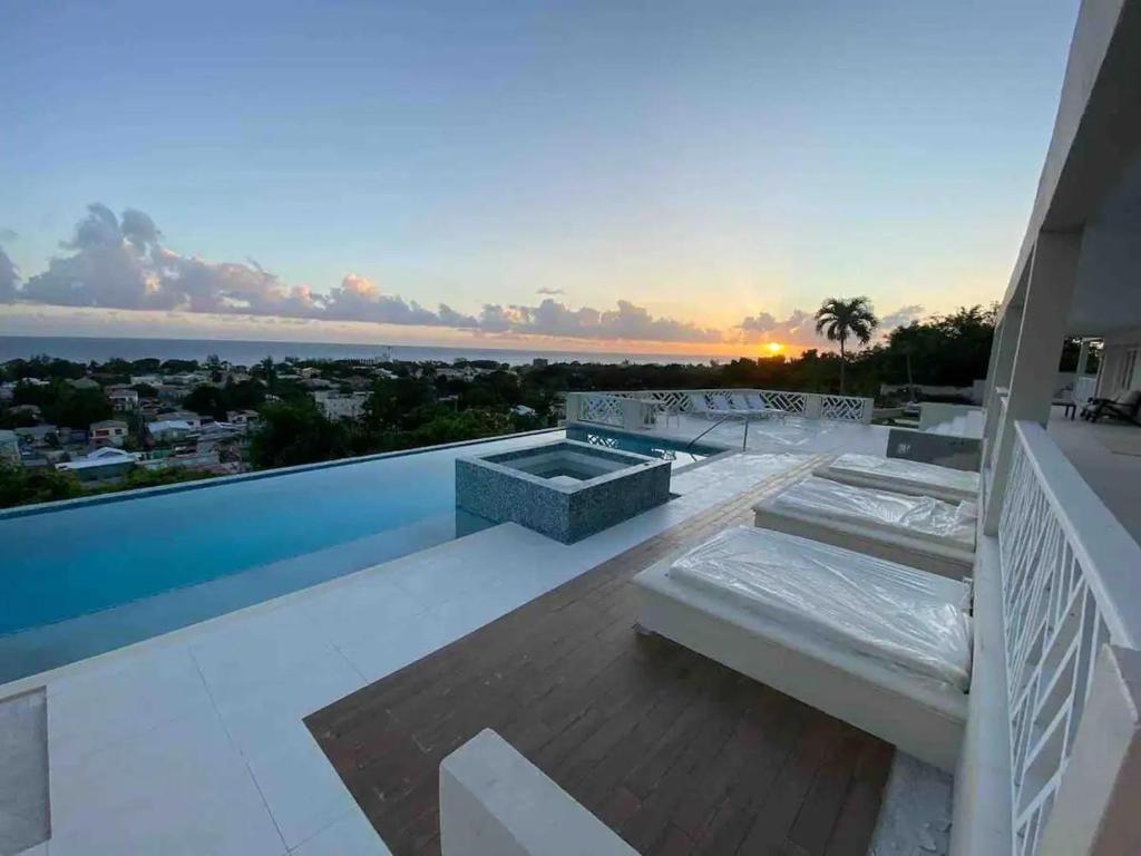 a balcony of a house with a view of the ocean at Luxury 4 Bed Villa in Barbados with amazing views in Bridgetown