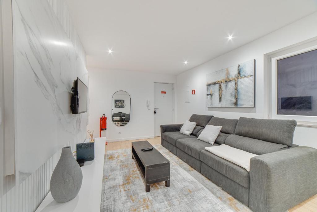 a living room with a couch and a table at Duplex Apartment near Belém in Lisbon