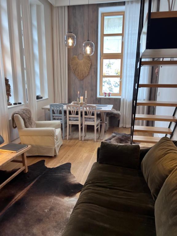 a living room with a couch and a dining room at SKI apartment by Mountain ways in Rokytnice nad Jizerou