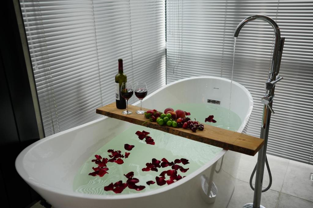 a bath tub with a tray of fruit and wine glasses at Honey moon15 in Istanbul