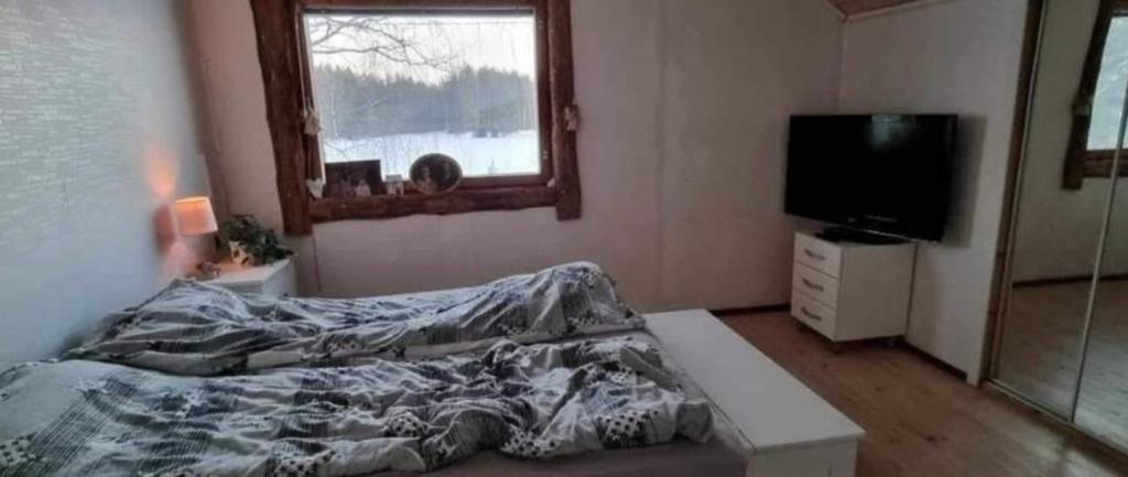 Rúm í herbergi á Urlaub mit Hund Bauernhof in Alleinlage in Finnland
