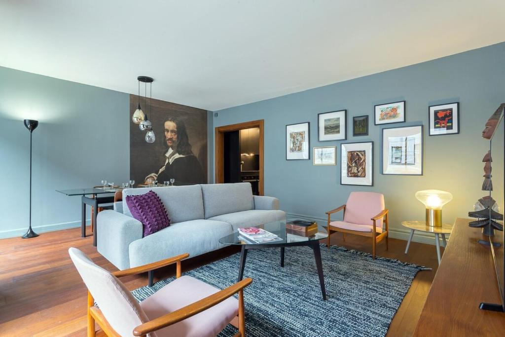 a living room with a couch and a table at Stella - 2 chambres-balcon- place de la République in Lyon