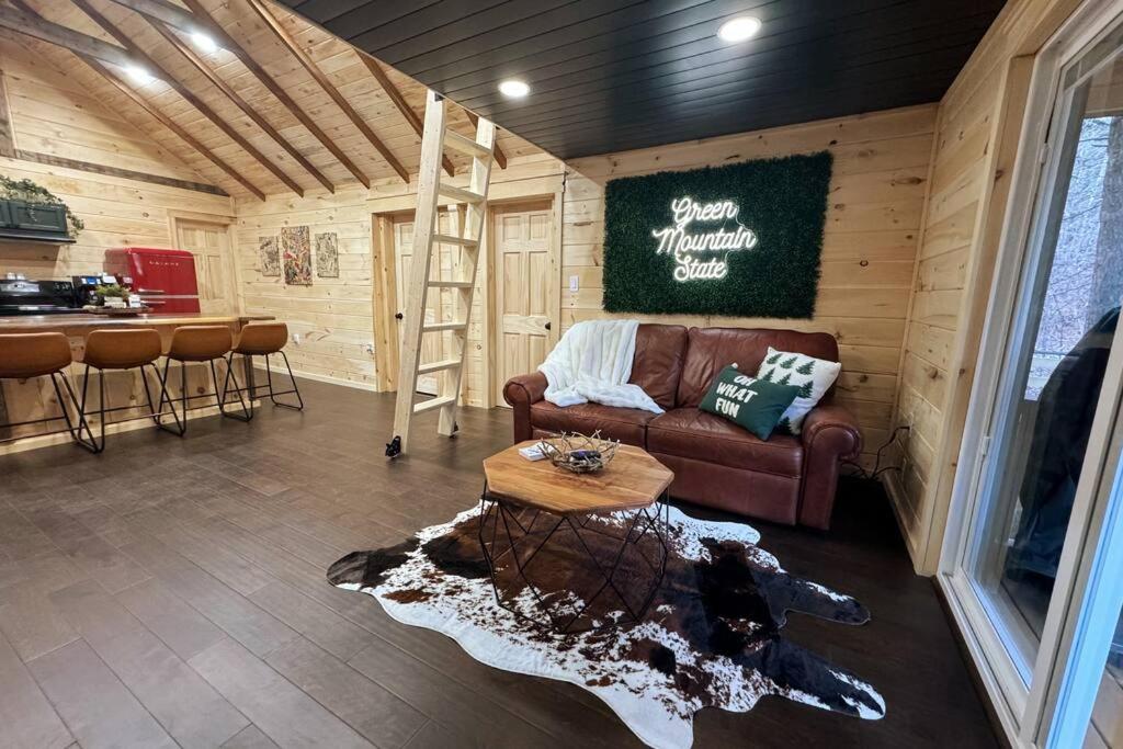 a living room with a couch and a table at Brook Haven Retreat - Minutes to Mt Snow / Stratton, Pet Friendly! in Wardsboro