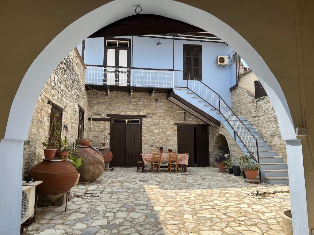 an archway with a staircase in a building with plants at Charming 1800s House - Lefkara Village Retreat in Pano Lefkara