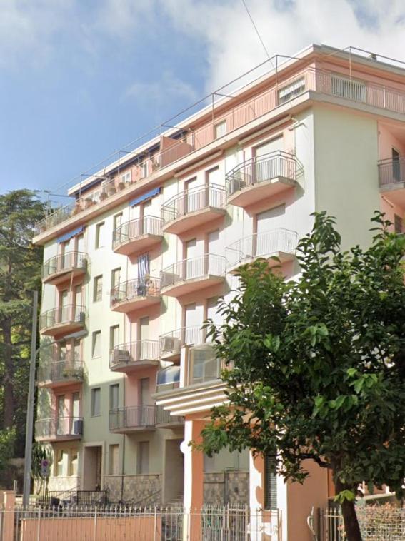 a tall building with balconies on the side of it at Casa Laura in Alassio