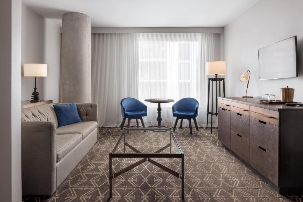 a living room with a couch and a table at Hotel Van Zandt in Austin