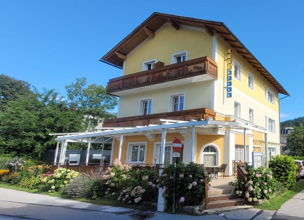 a large yellow building with a balcony at Sonnblick am Wörthersee in Pörtschach am Wörthersee