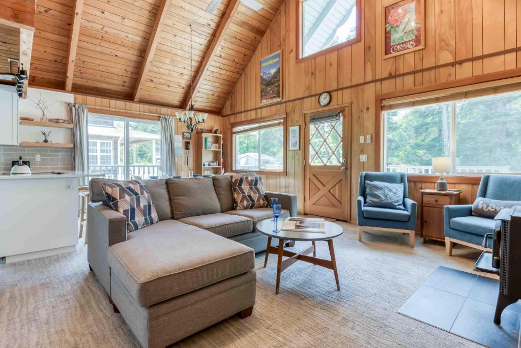 a living room with a couch and a table at Play Chalet MCA 489 - Meredith Lodging in Manzanita
