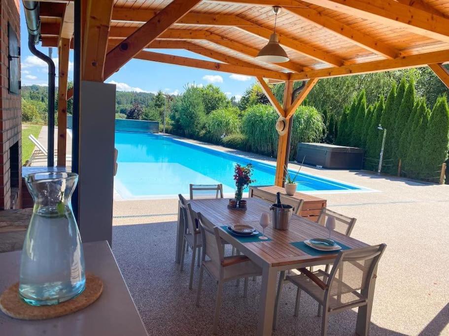 a table with chairs and a vase on a patio at Great spacious villa near Prague 