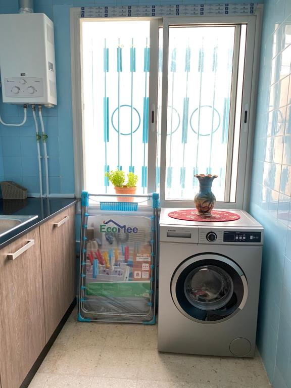 a washing machine and a washer in a kitchen at Résidence sassi in Nabeul