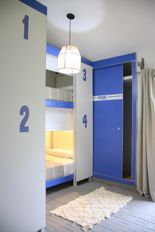 a room with two bunk beds and a blue door at BROTHERS HOSTEL in Villa Allende