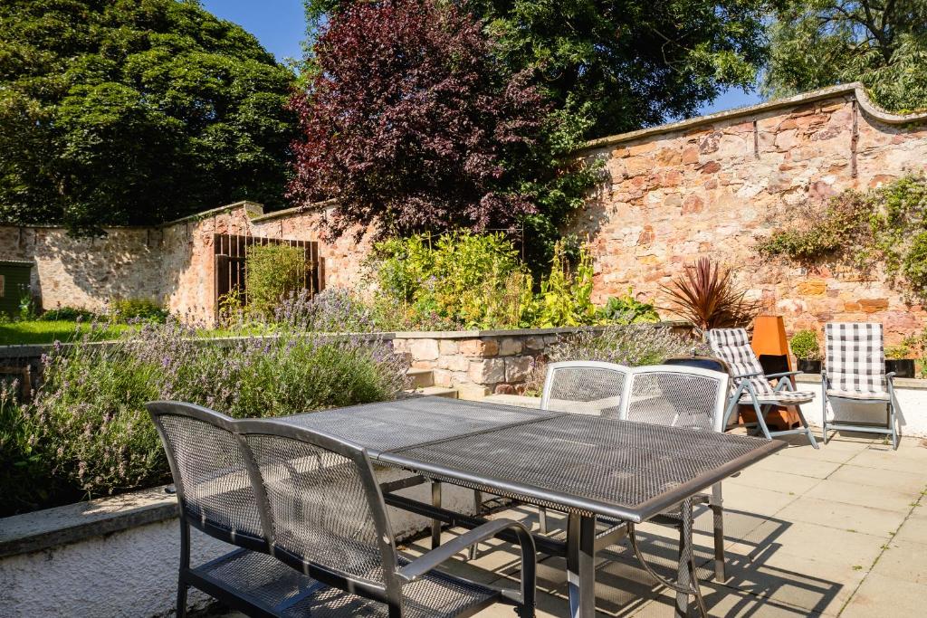 a table and chairs sitting on a patio at Garden Cottage, Crail in Crail