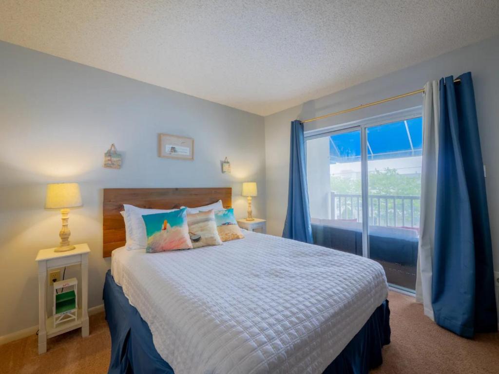 a bedroom with a bed and a large window at Wesley Paradise Chic1BD Private Balcony and Pool in Ocean City
