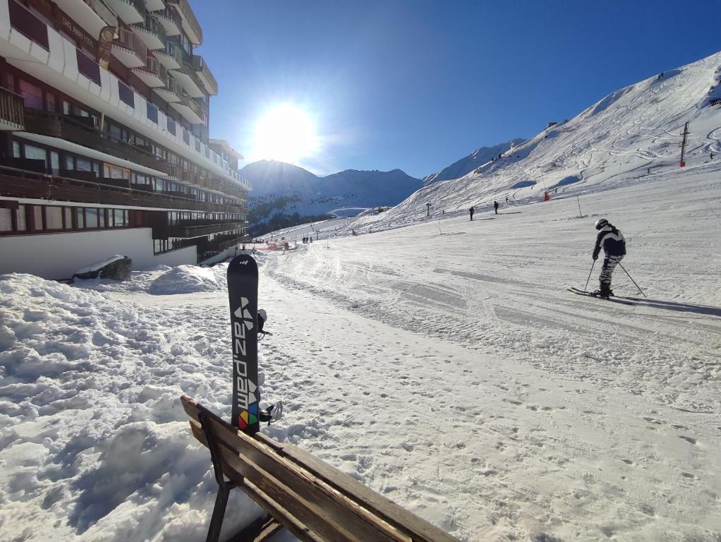 a person is skiing down a snow covered slope at Studio Cosy-Aux pieds des pistes-2100 m in Aime La Plagne