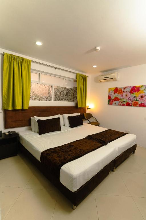 Uma cama ou camas num quarto em Hotel Boutique las Rosas 5 G