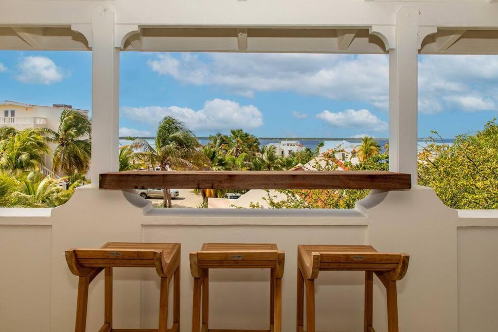 three stools sitting in front of a window with a view at Penthouse Flamboyant in Hato