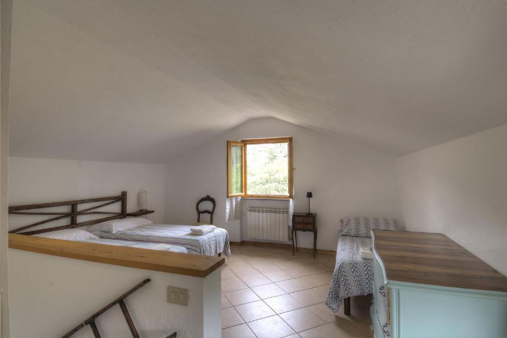 a bedroom with a bed and a table and a window at Casa Bartola in Stella