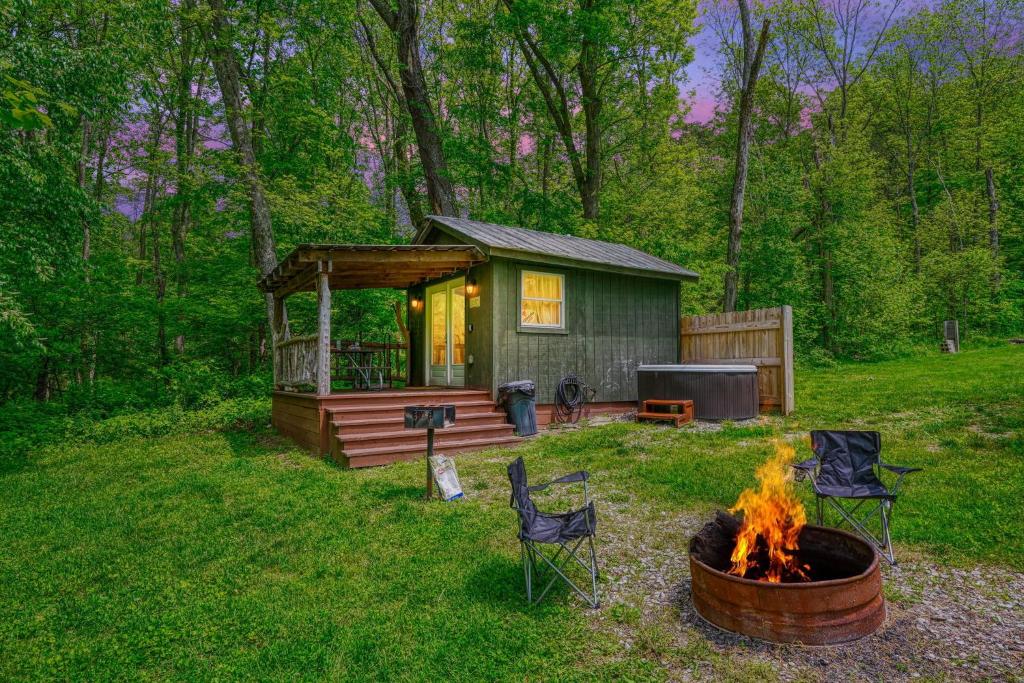 a cabin with a fire pit in front of it at Cypres Caban in Logan
