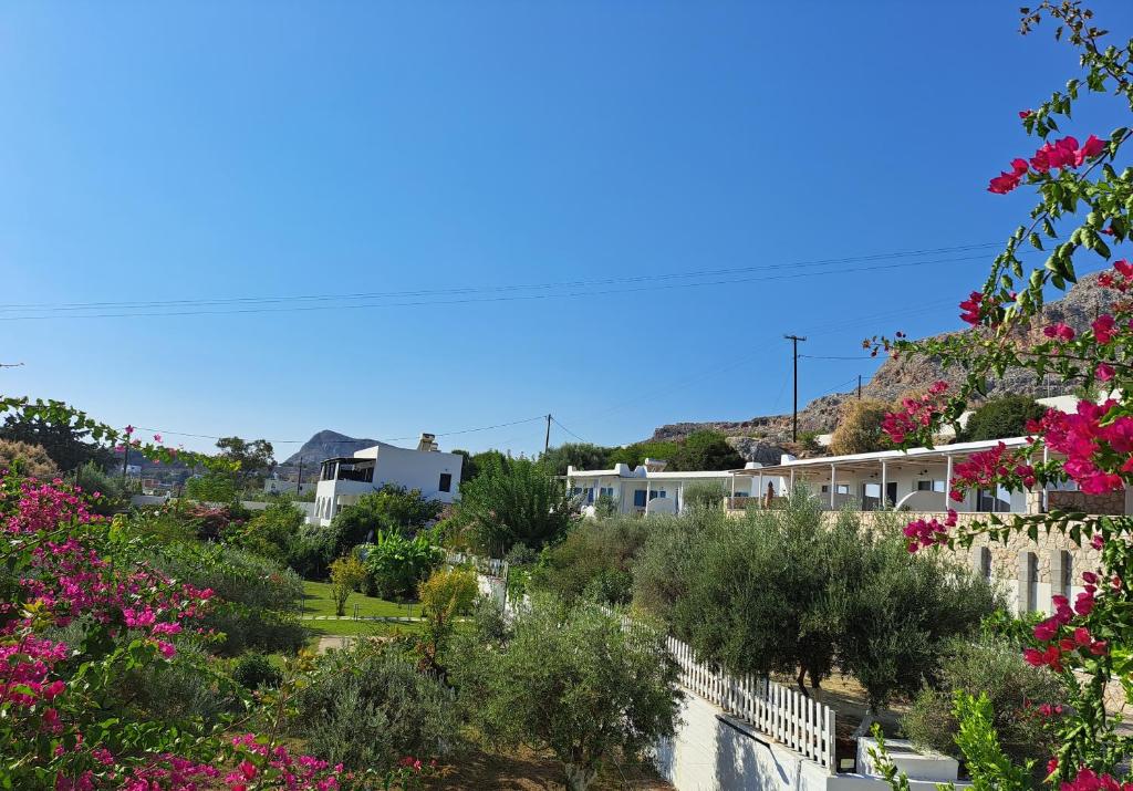 a view of a town with pink flowers at Anastasia's Garden in Archangelos