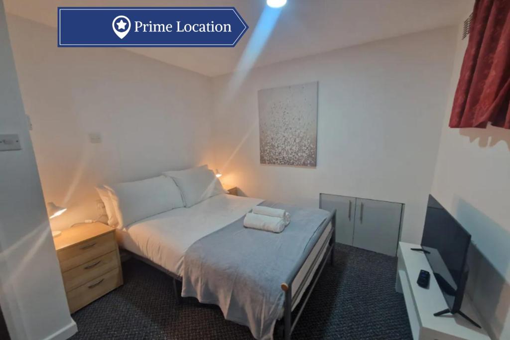 a small bedroom with a bed and a television at Classic Studio near Headingley Stadium in Headingley