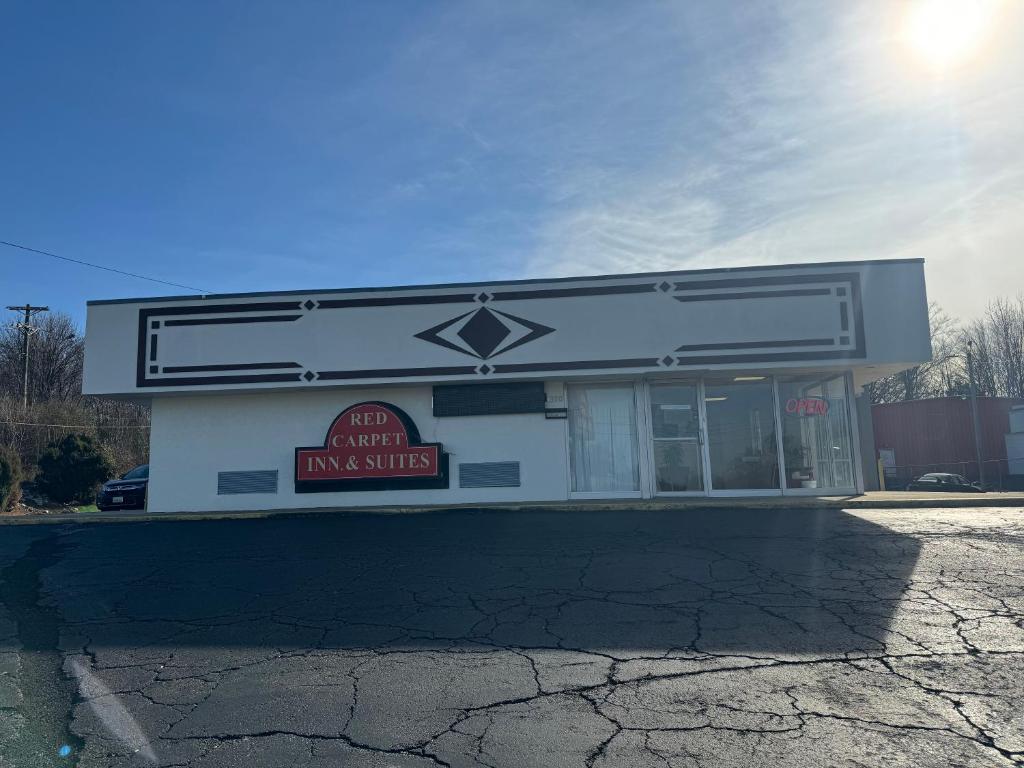 a building with a sign on the side of it at Red Carpet Inn & Suites - Danville in Danville