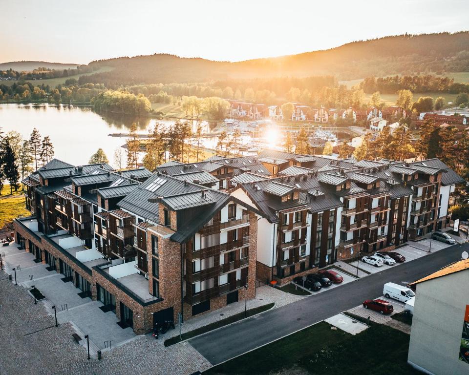 an aerial view of an apartment complex with a river at Molo Lipno resort luxusní apartmán 4kk in Český Krumlov