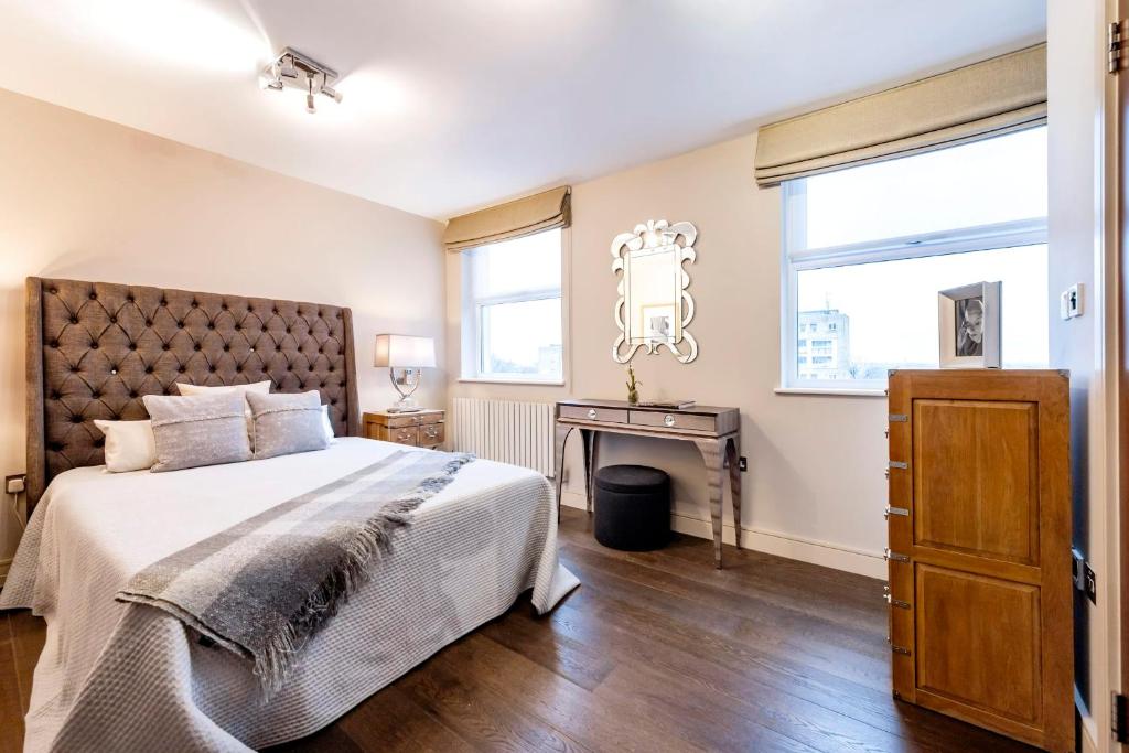 a bedroom with a large bed and a table at CAMDEN Lux Apartment-Hosted by Sweetstay in London