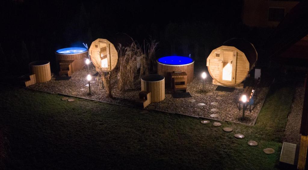 a group of wooden barrels with lights in the dark at Górskie Wytchnienie in Jelenia Góra