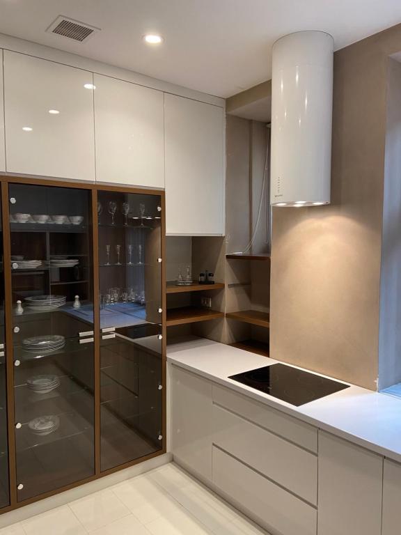 a kitchen with white cabinets and stainless steel appliances at Capital apartments Sarajevo in Sarajevo