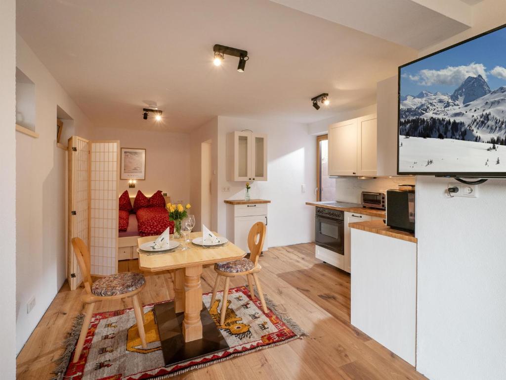 a kitchen and living room with a table and chairs at Latina II in Westendorf