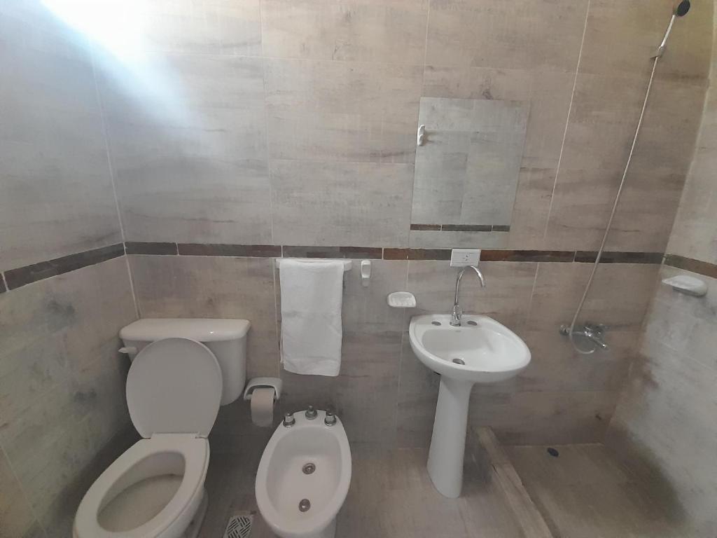 a small bathroom with a toilet and a sink at Departamento San Luis 1 in San Luis