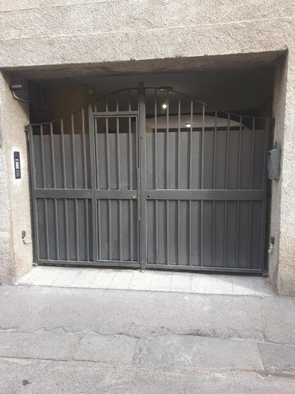 an entrance to a garage with a metal gate at Casa n 1 con parcheggio privato e colonnina ricarica in Livorno
