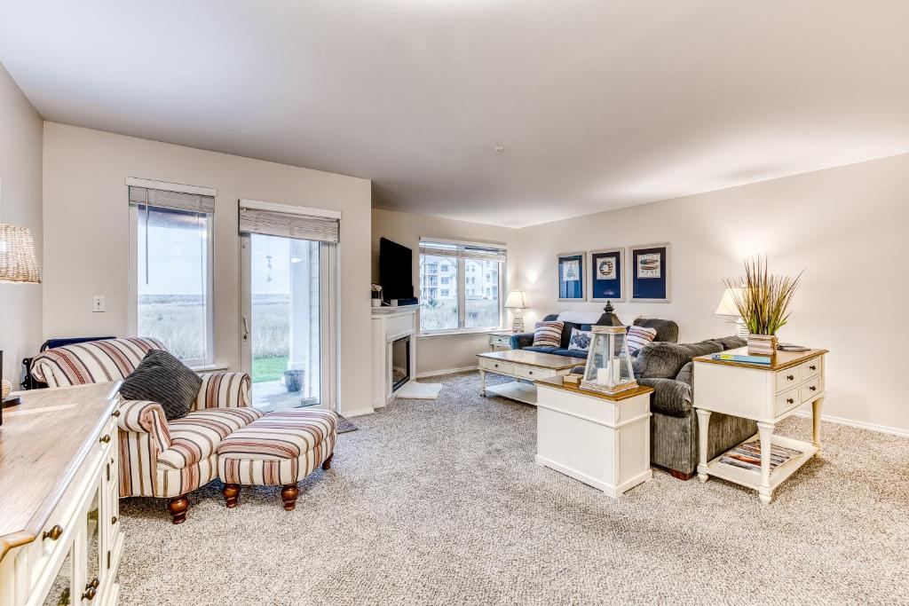 a living room with a couch and a table at Seconds from the Sand, Unit 312 in Westport