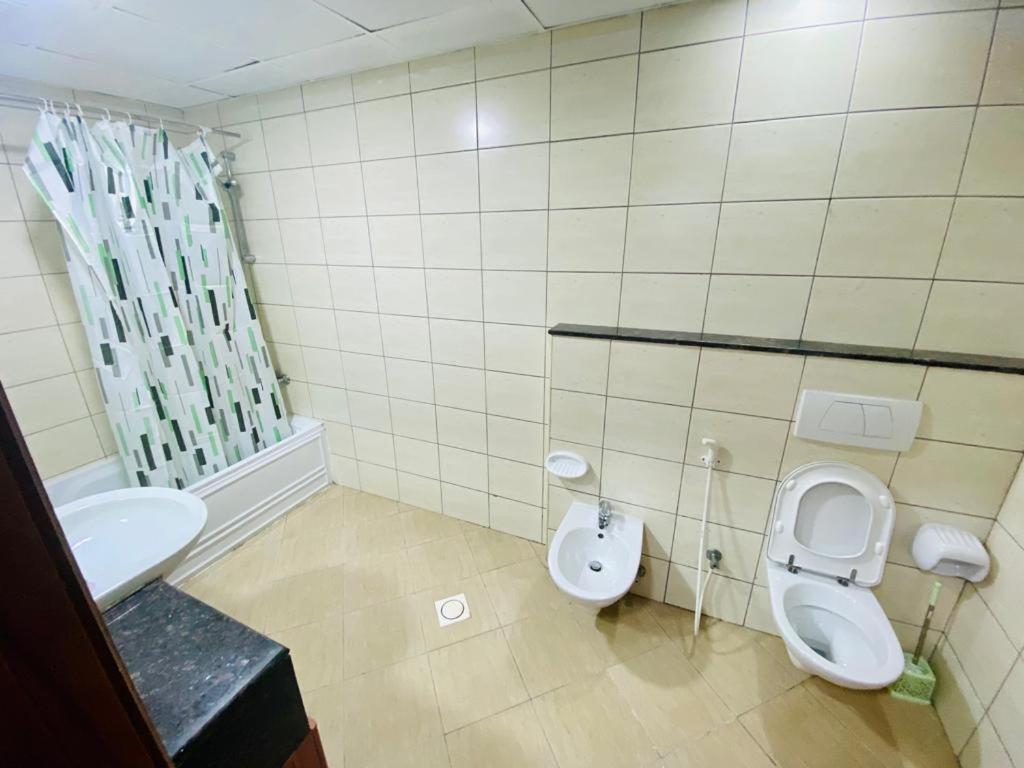 a bathroom with a toilet and a sink at Loft Partition close to Mall of Emirates in Dubai