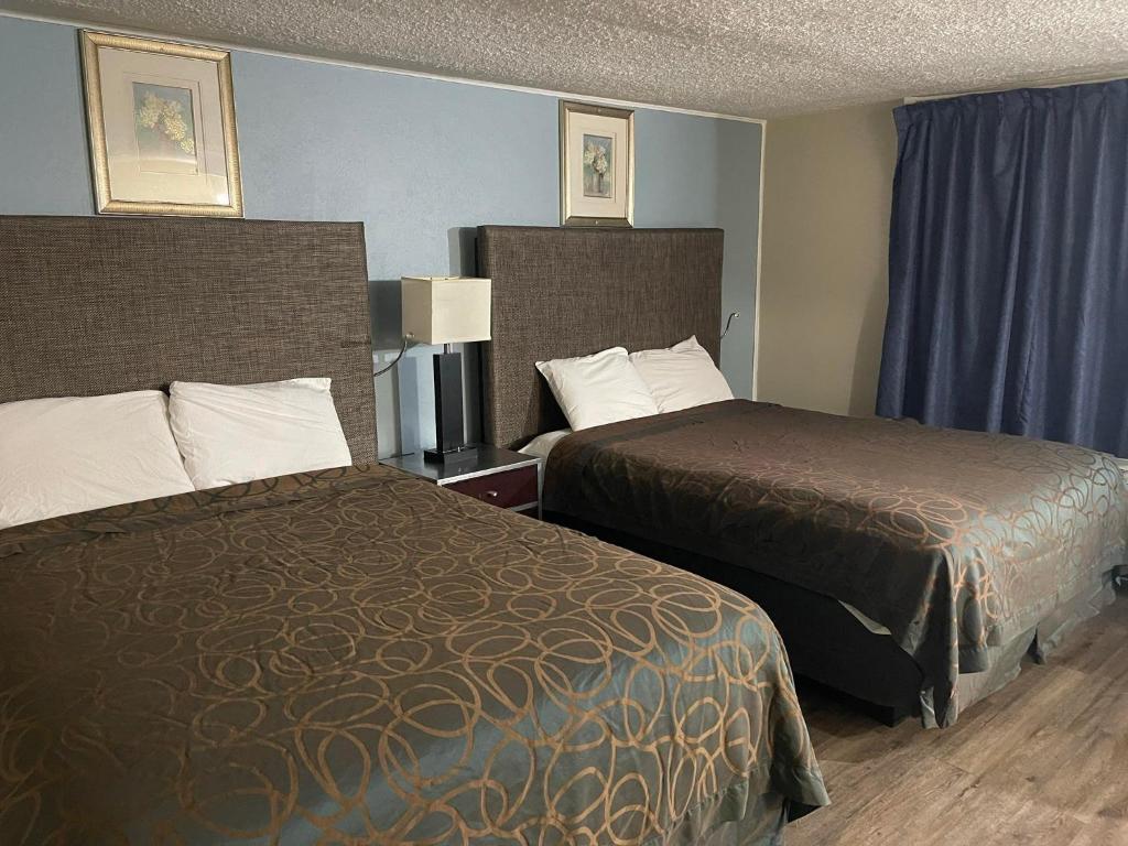 Ένα ή περισσότερα κρεβάτια σε δωμάτιο στο Safari Motel