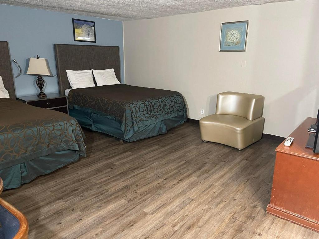 Ένα ή περισσότερα κρεβάτια σε δωμάτιο στο Safari Motel